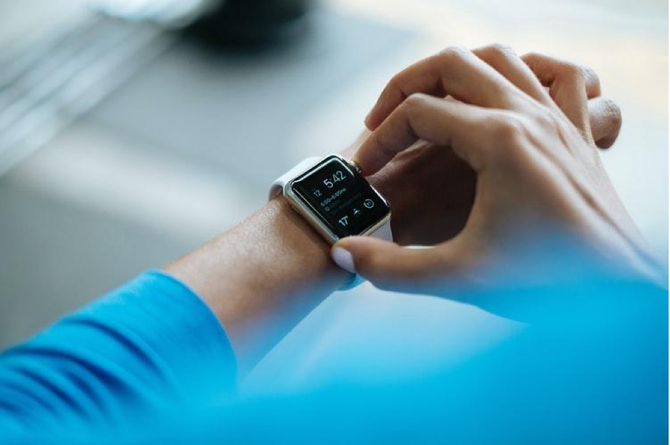 Woman using a white Apple watch