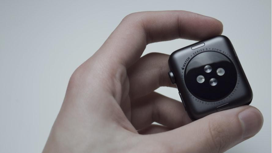 Hand holding a black Apple watch series 3